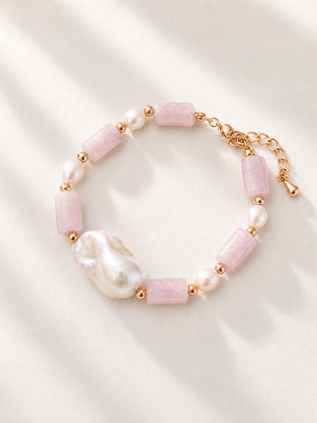 A high-definition studio shot of the Liora bracelet, showcasing the unique, non-uniform shapes of the natural pearls and the soothing lilac tones of the Kunzite beads.